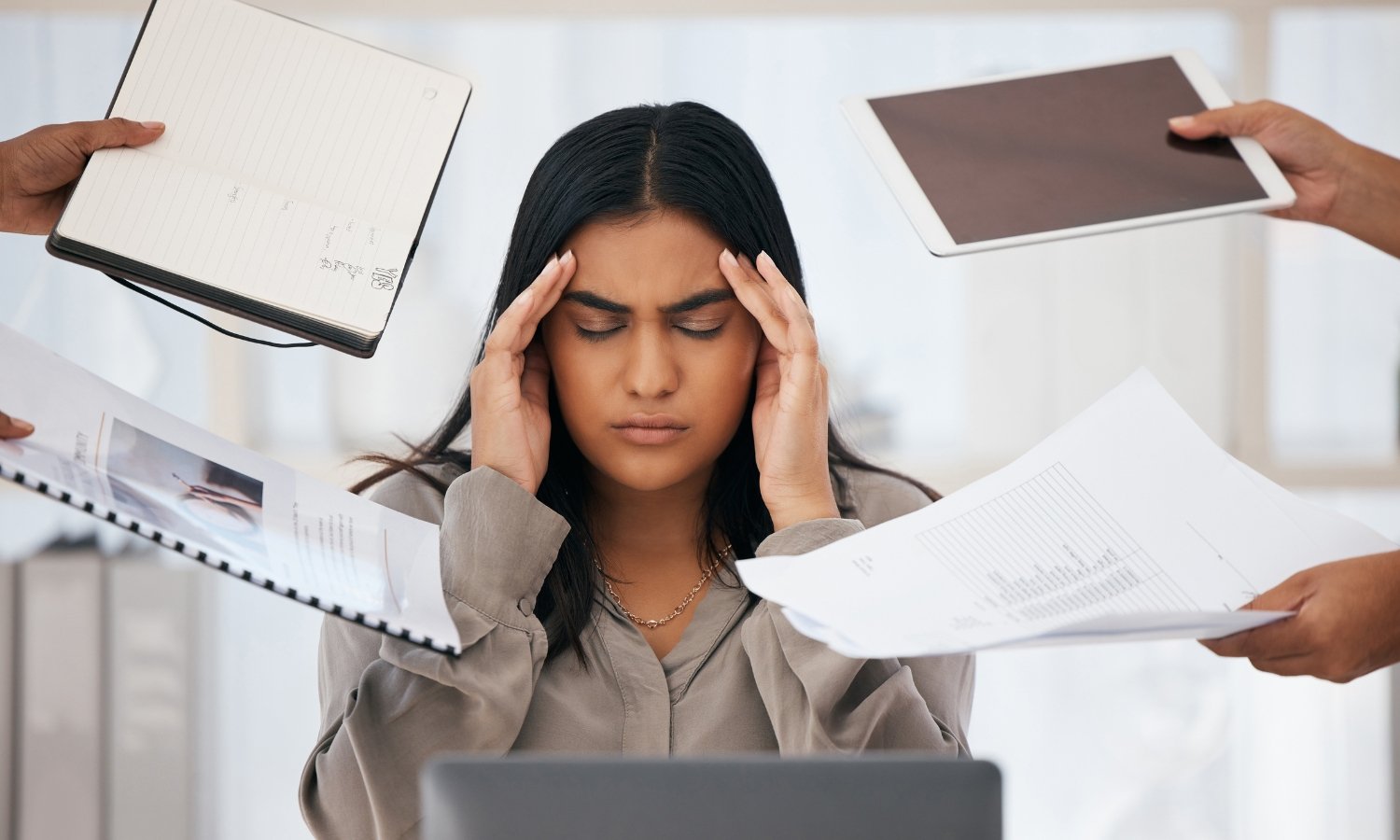 A businesswoman struggling to manage a chaotic work environment characterized by overflowing paperwork and uncompleted tasks.