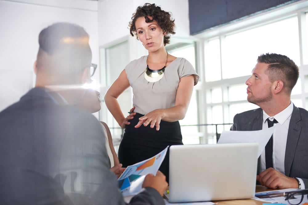 team of successful business people having a meeting in executive sunlit office